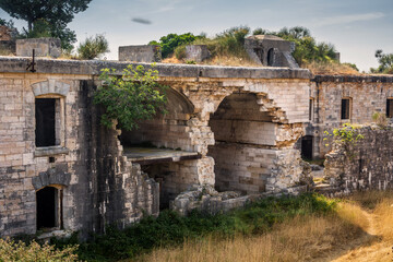 Ruins of Austro-Hungarian Fortification Fort Forno in Istra, Croatia. Beautiful historical fortress made of stone. Abandoned landmark dating back to 1904 covered with vegetation in bad shape