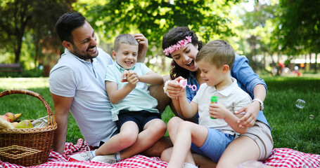 Fototapeta premium Family picnic outdoors togetherness relaxation happiness concept