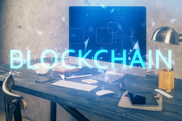 Double exposure of blockchain and crypto economy theme hologram and table with computer background....