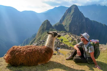 Photo sur Plexiglas Machu Picchu Touriste et lama assis devant le Machu Picchu, Pérou