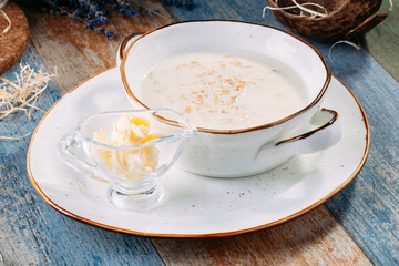 Healthy breakfast oatmeal porridge with butter