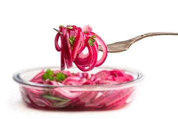 Marinated pickled red onion rings on fork isolated on white