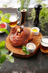 Baked pork knuckle in Bavarian style. Suggestion of serving a dish on a plate. food background