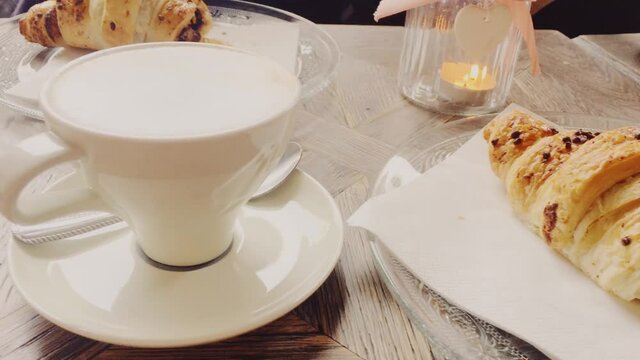 Cappuccino and chocolate croissant in cafe, cup of coffee and pastry dessert for breakfast, food and baked goods close-up