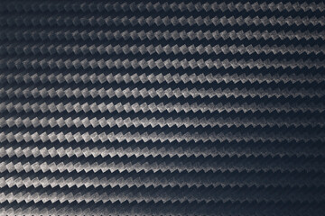 Macro photo of grey carbon fiber pattern texture.