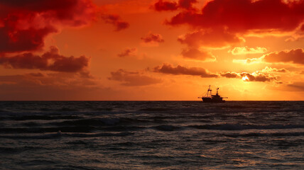 Naklejka na ściany i meble fishing boat in the sunset
