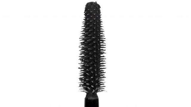 black mascara moving around on white background 