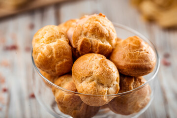 Small sweet dessert profiteroles in a glass