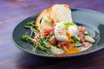Homemade salad with vegetables and poached egg. Breakfast.