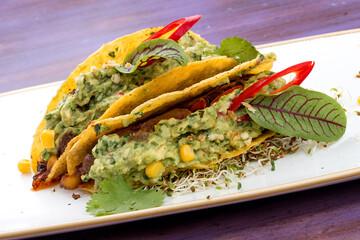 Taco. Corn tortilla with beef and guacamole with spices.