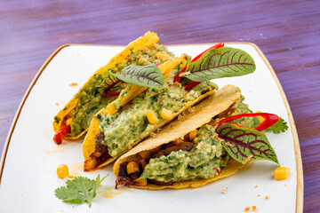 Taco. Corn tortilla with beef and guacamole with spices.