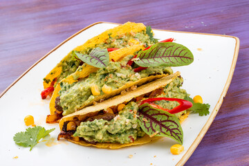 Taco. Corn tortilla with beef and guacamole with spices.