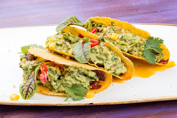 Taco. Corn tortilla with beef and guacamole with spices.