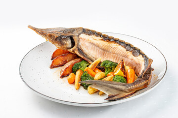 Sturgeon baked with potatoes and steamed vegetables
