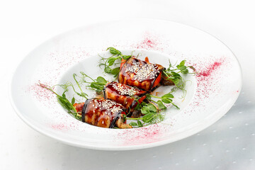 Eggplant rolls with smoked eel and tomatoes