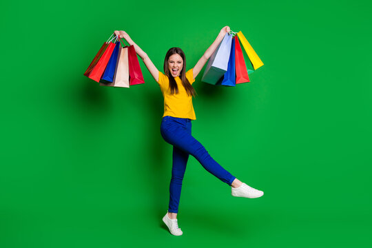 Full length body size view portrait of nice attractive overjoyed fashionable cheerful cheery girl jumping carrying new cool good things isolated bright vivid shine vibrant green color background
