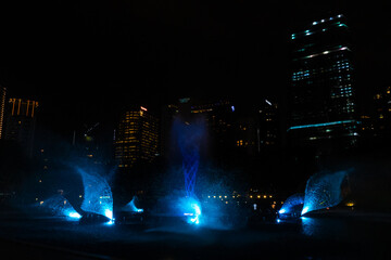 Night view of the dancing multi-colored fountains. Show of Singing Fountains