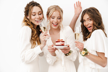 Photo of excited bridesmaids eating cake and drinking champagne