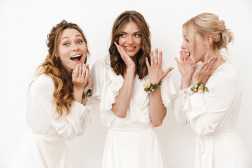 Photo of attractive happy bride showing her wedding ring at bridesmaids
