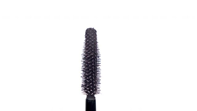 black mascara moving around on white background 