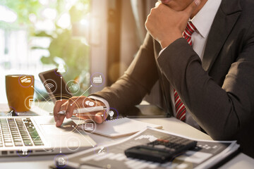 Business and financial concepts about office work. Analysts discuss business with laptop and...