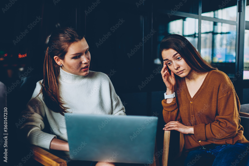 Poster concentrated female it developers thinking on installing application on laptop computer, puzzled you