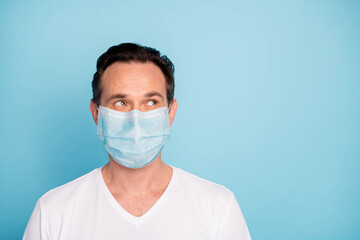 Close-up portrait of his he nice pensive guy wearing safety gauze mask stop pathogen mers cov influenza contamination viral pneumonia thinking isolated bright vivid shine vibrant blue color background