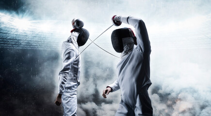 Portrait of two fencers against the backdrop of a sports arena. The concept of fencing. Duel.