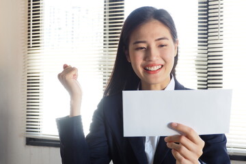 Young active Asian woman is excited with her happy face smiling and raising her hand up Job...