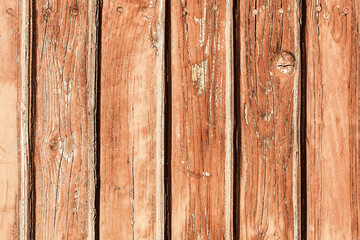 Fototapeta premium Old peeling paint texture. Grunge cracked wooden wall background. Red color weathered surface. Broken wood desk structure. Vintage board pattern design.