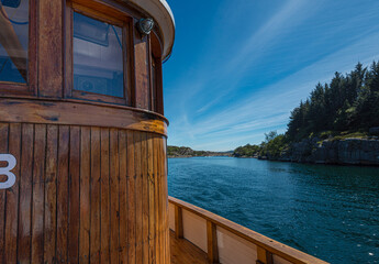 Wheelhouse of a wooden fishing boat by the coast © Trygve