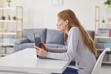 Young girl talking to family or friends, conducting business meeting or teaching online from home