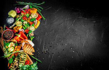 Grilled vegetables and mushrooms with basil and dry herbs on a dark background. Vegan grill concept