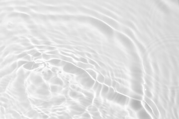 Fototapeta na wymiar Closeup of desaturated transparent clear calm water surface texture with splashes and bubbles. Trendy abstract nature background. 
