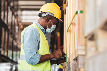 African worker wear protective face mask in warehouse