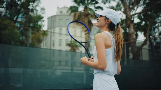 Female tennis player feeling happy and excited for winning  match, playing professional tennis, emotions after hard game