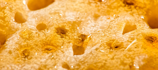 Macro photo of a toasted crumpet with honey