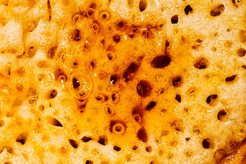 Macro photo of a toasted crumpet with honey