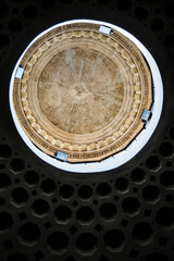 Ceiling under the dome of a Roman church with an engraved bird in the center in Rome