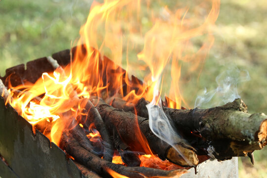 Fire with coals on a picnic . Preparing coals for cooking meat. Outdoor activities. 