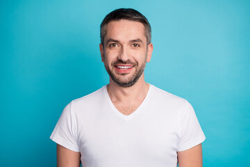 Close-up portrait of his he nice attractive content cheerful cheery bearded guy wearing tshirt beaming smile isolated over bright vivid shine vibrant blue color background