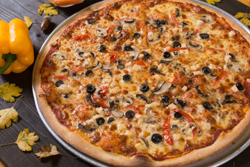Fresh just made pizza with vegetables, spices for pizza in restaurant.