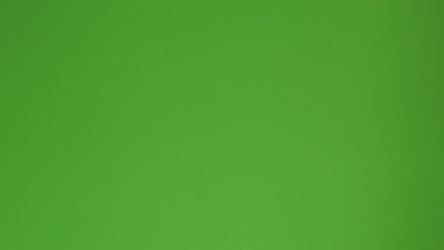 invisible hand pulling a window curtain from left to right in front of green screen so you can change the background via chroma key, Opening transition and ungraded 4k footage, establishing shot.