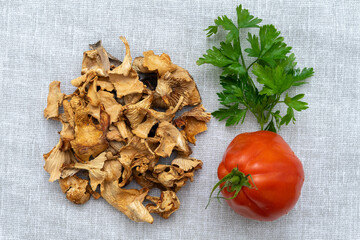mushrooms, tomato and greens on a canvas napkin. culinary layout