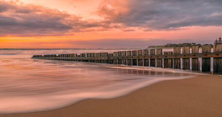 Obraz premium Sunrise on Torquay beach, Surf Coast, Victoria, Australia featuring the wooden groyne