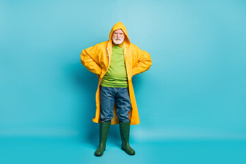 Full length body size view of his he nice dissatisfied grey-haired man fisherman wearing yellow...