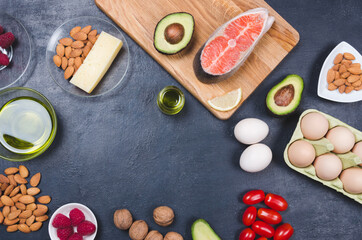 Obraz na płótnie Canvas Keto diet, low carb healthy food. avocado, fish, oil, nuts on black background