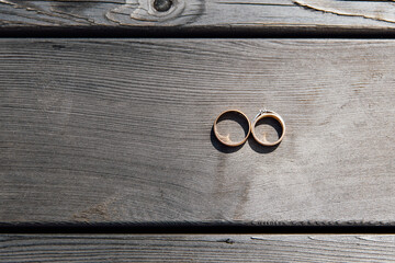 
wedding rings on a wooden board