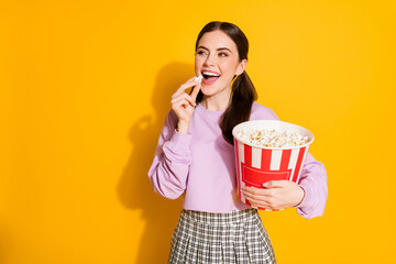 Portrait of positive cheerful girl enjoy cinema watching eat big pop corn box wear checkered...