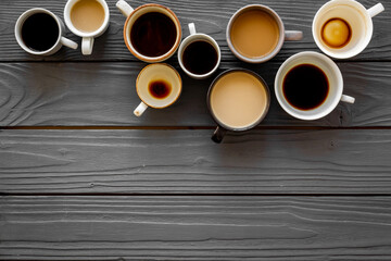 Many cups of coffee on wooden desk top view space for text